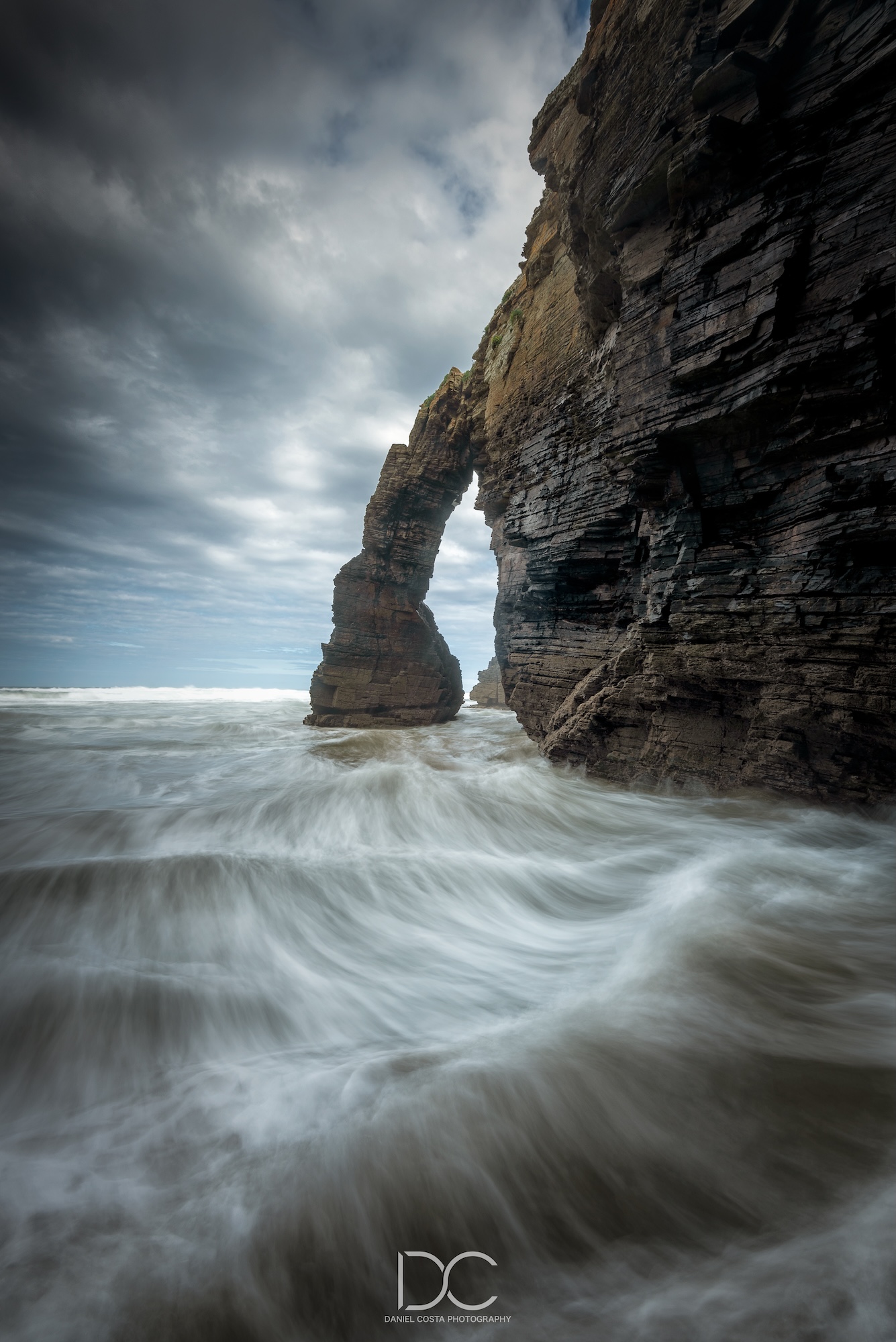 Dramatic moving sea by the mountain