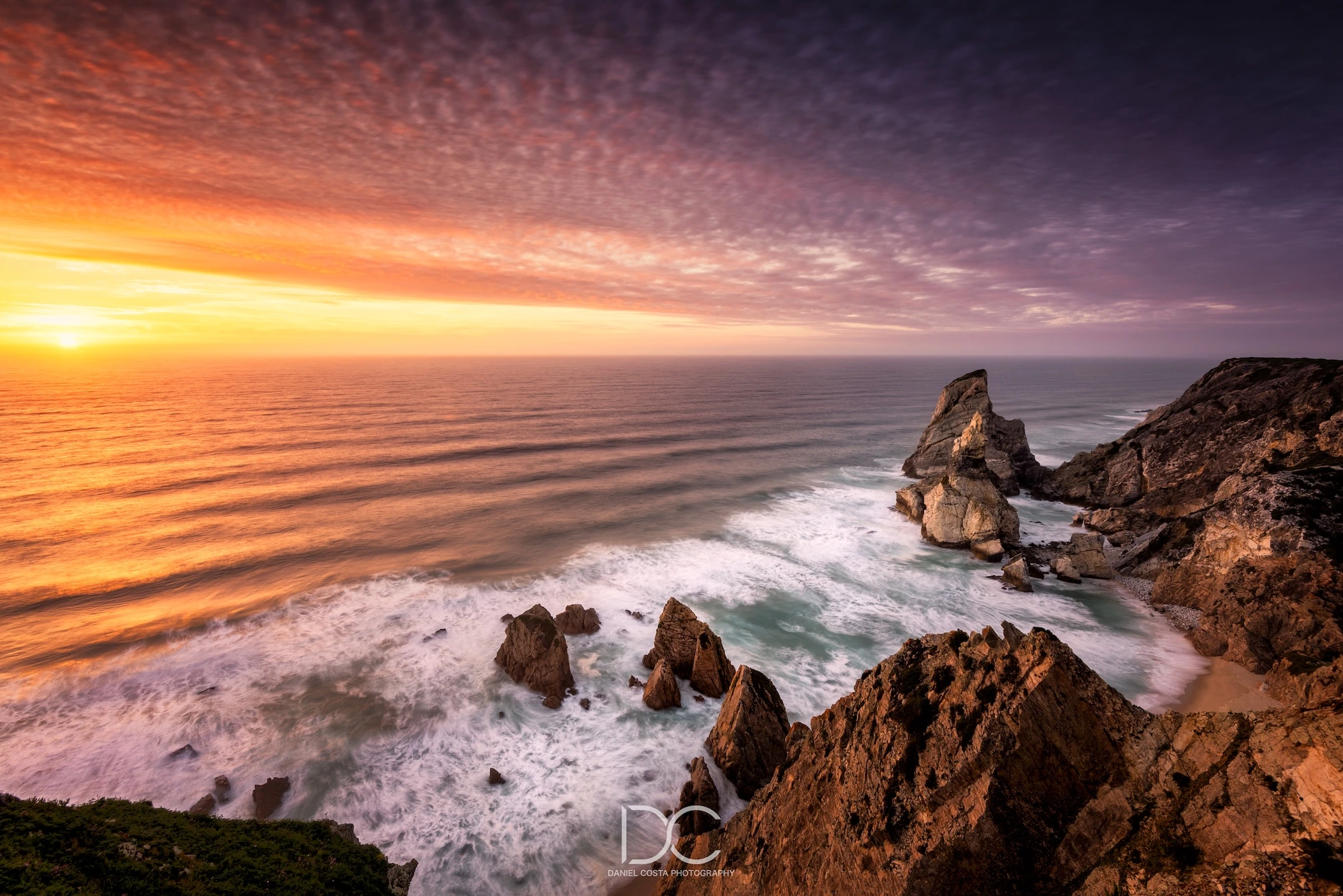 Seascape bathed by sunlight by the rocks